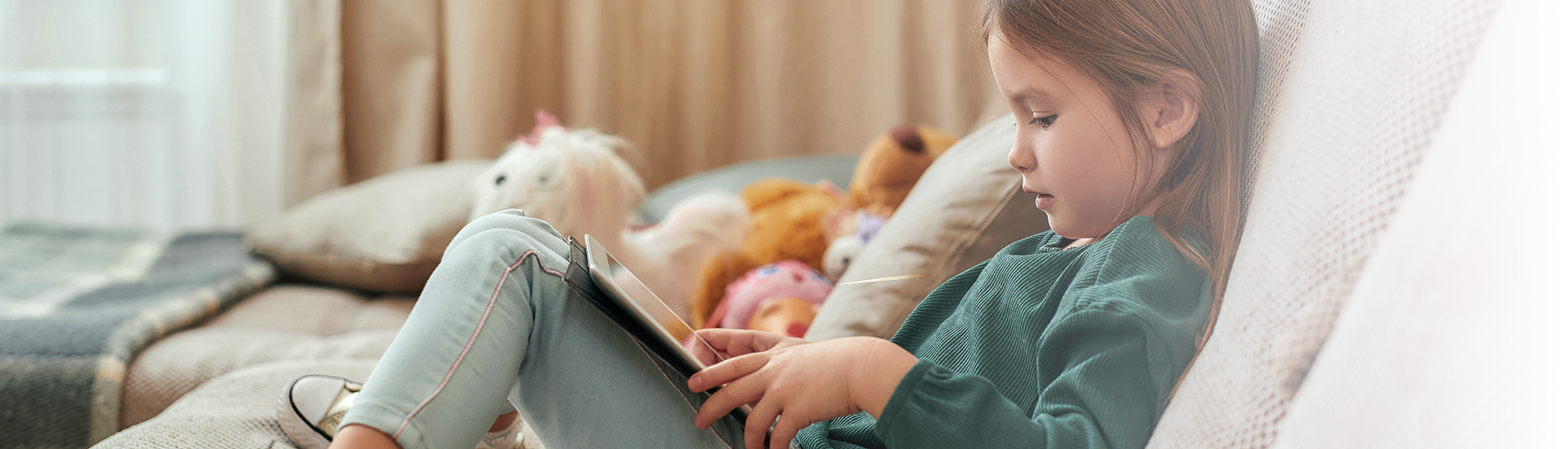 Girl on sofa with tablet